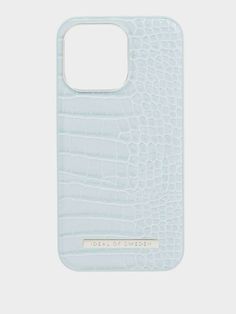 the back of a white phone case with an alligator skin pattern and gold lettering on it