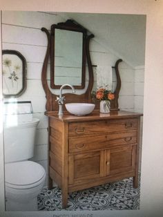 a bathroom with a sink, mirror and toilet