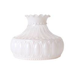 a white vase sitting on top of a table