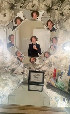 a woman taking a selfie in front of a mirror with her family photos on it