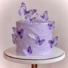 a purple cake with butterflies on it