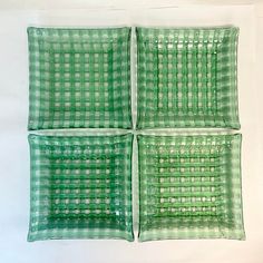 four green glass plates sitting on top of each other