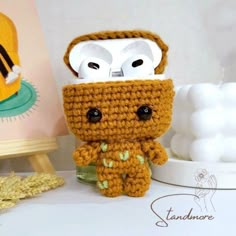 a small crocheted toy with an owl on it's head and eyes