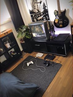 a living room with an entertainment center and guitar