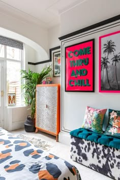 a colorful bedroom with posters on the wall