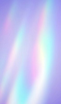 a blurry image of rainbow colors in the sky with white and blue highlights on it