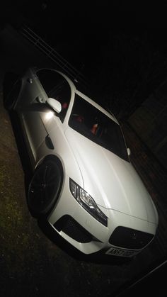 a white sports car parked in the dark