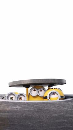 two minions from the movie despicable me are sitting in front of a skateboard