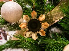 an ornament is hanging from a christmas tree with other ornaments on the branches