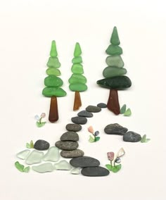 some rocks and trees on a white surface