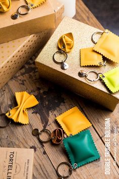 some yellow and green items are on a wooden table next to two boxes with scissors