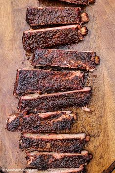 sliced meat sitting on top of a wooden cutting board