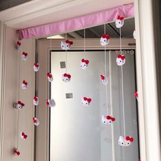 hello kitty decorations hanging from the ceiling in front of a mirror