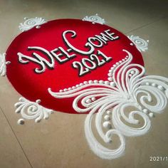 a welcome sign on the floor with white swirls