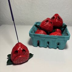 some strawberries are in a blue container