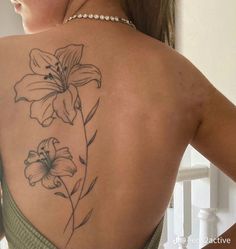 the back of a woman's shoulder with flowers on it