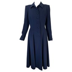 1940s navy blue wool princess coat, from Peterson Gerzog, Providence Rhode Island. A beautiful classic wool coat with amazing details such as, hand bound button holes, hand covered embroidered buttons at the front and on the turned back cuffs, the lining is hand sewn. The coat buttons up to the neck and has a wing collar. The shoulders are padded and add great definition to the coat shoulders. The coat is seamed through the waist from the bust to the hip top front & back. The coat skirt is light Embroidered Buttons, Princess Coat, Coat Skirt, Providence Rhode Island, Wing Collar, Button Holes, Blue Wool, Rhode Island, Wool Coat