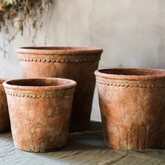 three clay pots sitting on top of a table