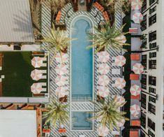 an aerial view of a building with palm trees