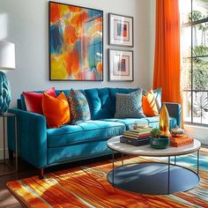 a living room with orange curtains and blue couches in front of a large window