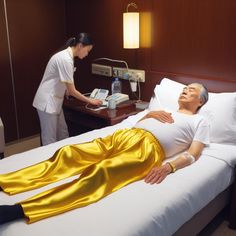 a woman laying on top of a bed next to a man in a white shirt