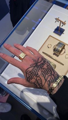 a person's hand with tattoos on it and other items in front of them