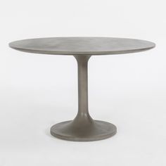 a round table with a metal base on an isolated white background, it is made from concrete