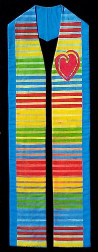 a colorful striped vest with a heart on the front and side, hanging from a black background