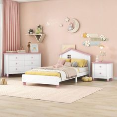 a child's bedroom with pink walls and white furniture, including a twin bed