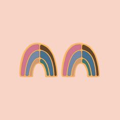 two rainbow shaped stickers on a pink background