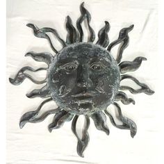 a metal sun face on a white background