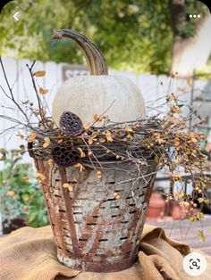 a white pumpkin sitting on top of a basket