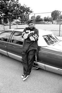 a man standing next to a parked car