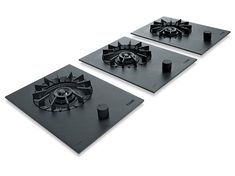 two black stove top burners sitting next to each other