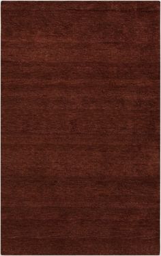 an area rug with dark brown colors