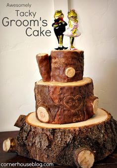 there is a cake made to look like two people on top of a tree stump