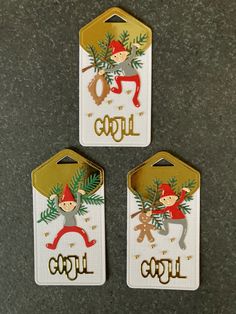 three tags with the words girl and two gnomes on them, hanging from a wall