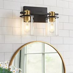 a bathroom light with two lights on the wall and a mirror in front of it