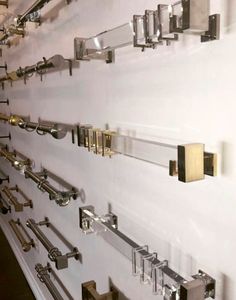 the wall is lined with metal and glass brackets on it's sides, which are attached to each other