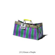 a purple and green striped bag sitting on top of a white floor next to a yellow handle