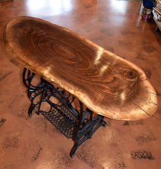 a wooden table sitting on top of a metal stand