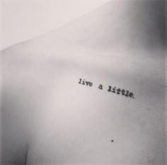 a black and white photo with the words live a little written on it's chest