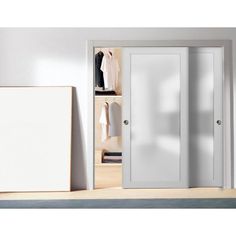 an open closet with white doors and clothes hanging on the shelves in front of it