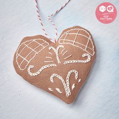 a heart shaped ornament hanging from a string