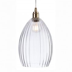 a clear glass pendant light hanging from a ceiling fixture with a gold metal fitting on the end