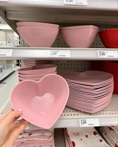 pink heart shaped dishes on shelves in a store