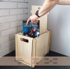 a person reaching into a magazine holder made out of plywood