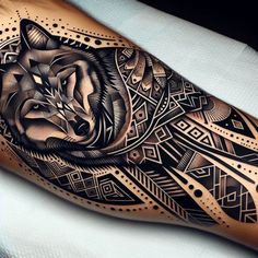 a black and white tattoo with a wolf on it's arm, done by an artist