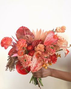 a person holding a bouquet of flowers in their hand