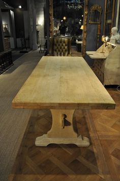 a wooden table sitting on top of a hard wood floor